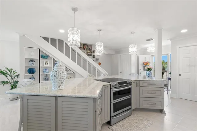 a view of kitchen and kitchen with granite countertop stove top oven