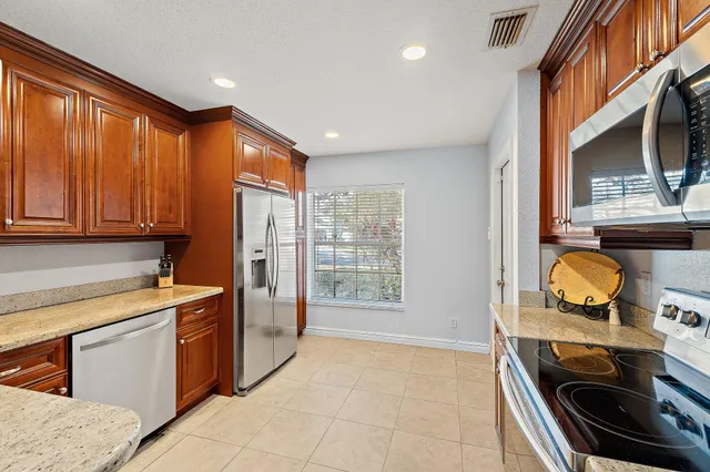 a view of a kitchen with a sink stove and a window