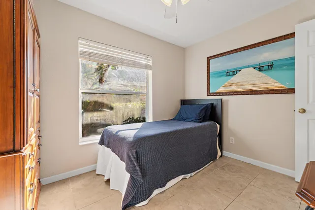 a bedroom with a bed and glass window