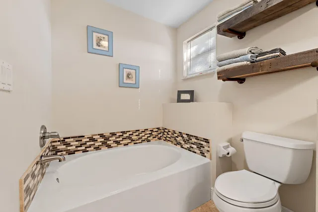 a white toilet sitting next to a white sink
