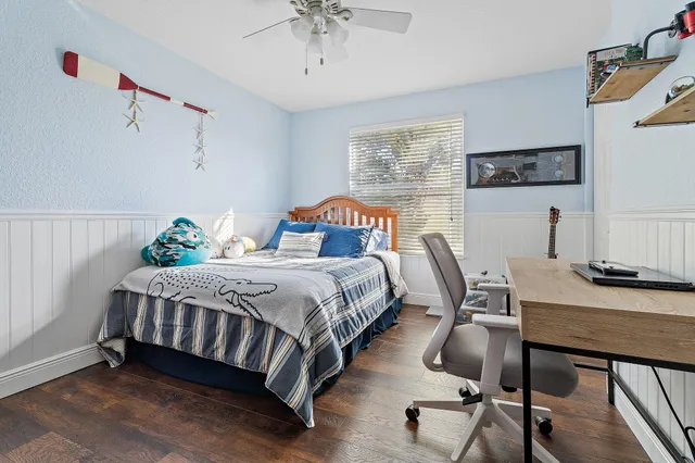 a bedroom with a bed and a desk