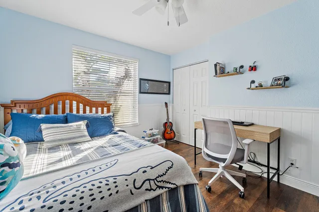 a bed room with a bed and a chair