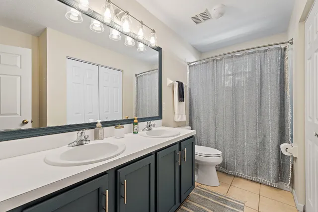 a bathroom with 2 sink and a mirror