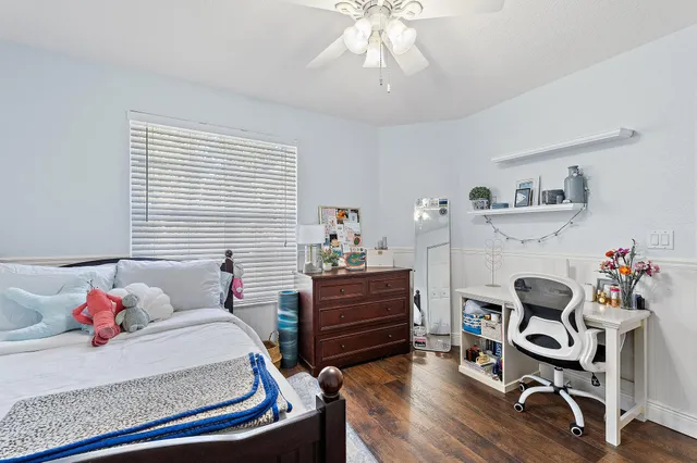 a bedroom with furniture and wooden floor
