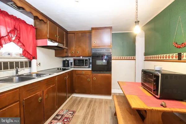 a kitchen with stainless steel appliances a sink and a stove