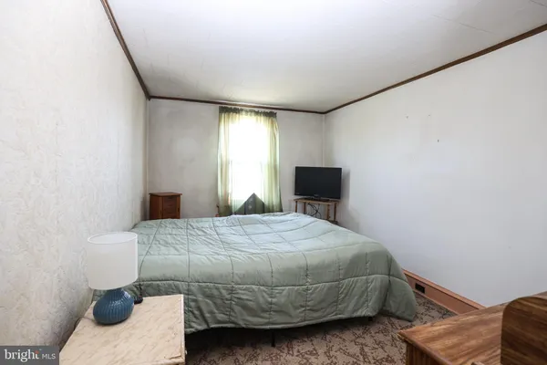 a bedroom with a bed and a chair