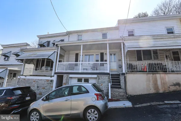 a front view of a house with parking space