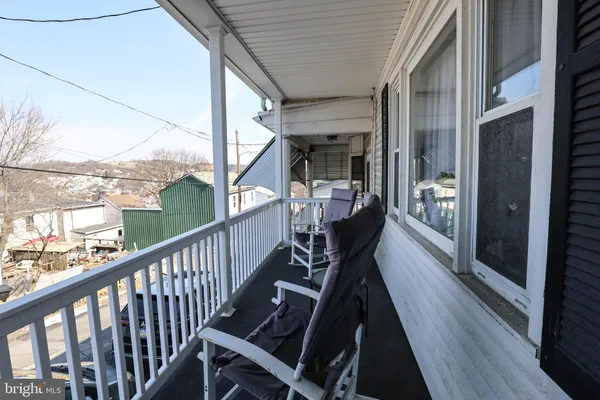 a view of balcony with wooden floor