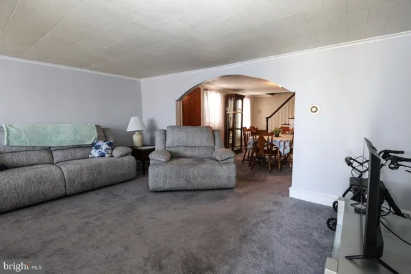 a living room with furniture and a mirror