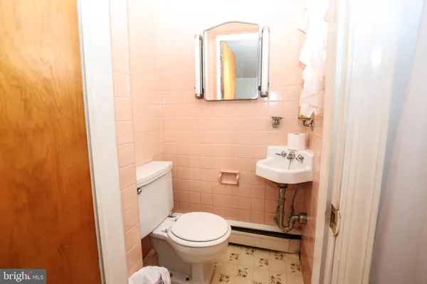 a white toilet sitting next to a bathroom sink