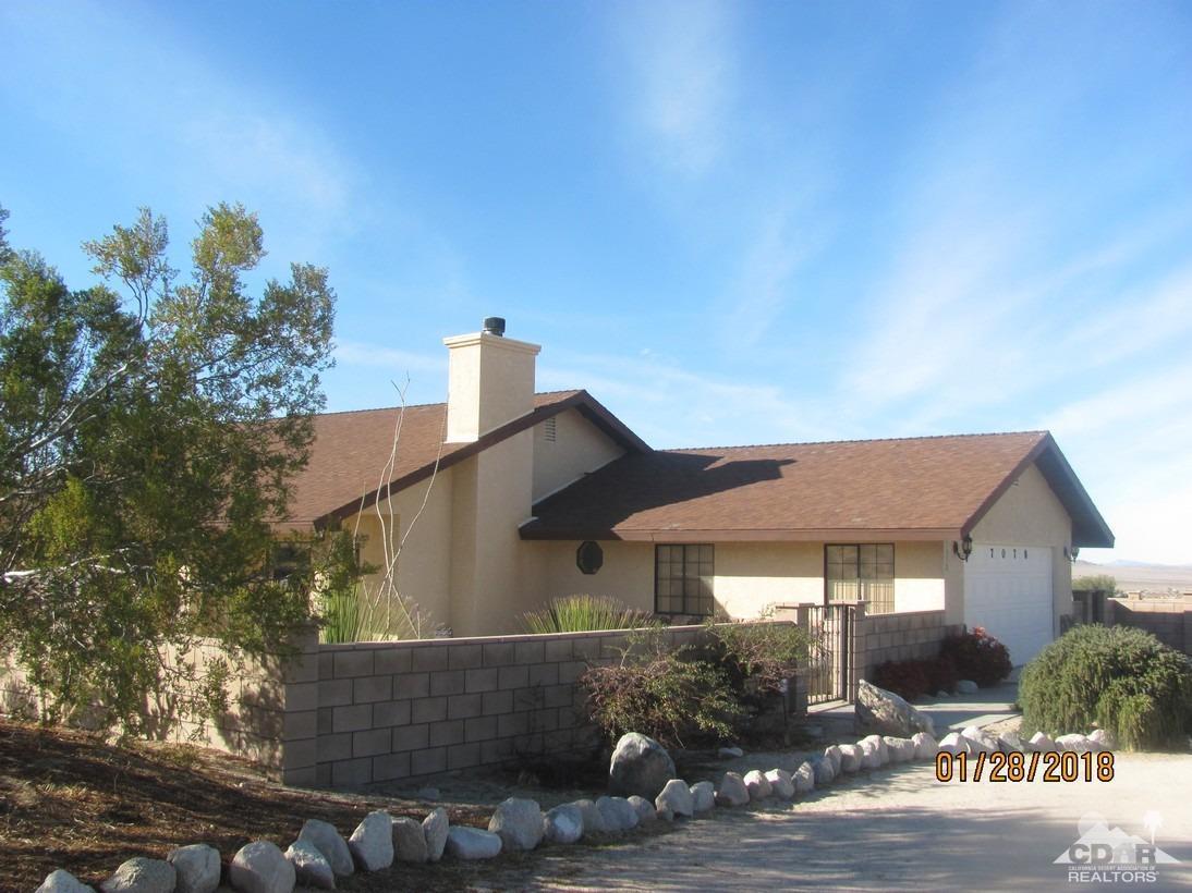 7078 Cascade Road Joshua Tree, CA 92252 - Photo 1 of 21 a front view of a house with garden