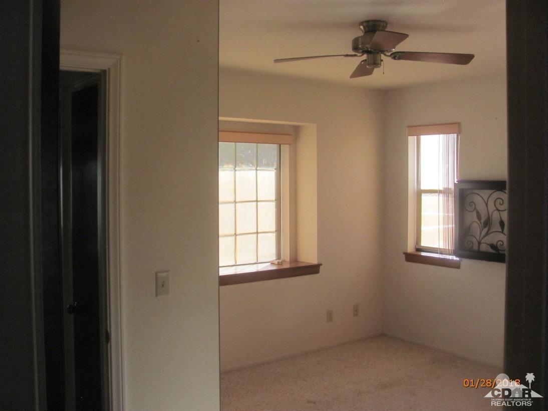 7078 Cascade Road Joshua Tree, CA 92252 - Photo 11 of 21 an empty room with windows and fan
