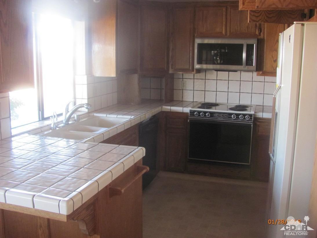 7078 Cascade Road Joshua Tree, CA 92252 - Photo 8 of 21 a kitchen with a stove and a microwave