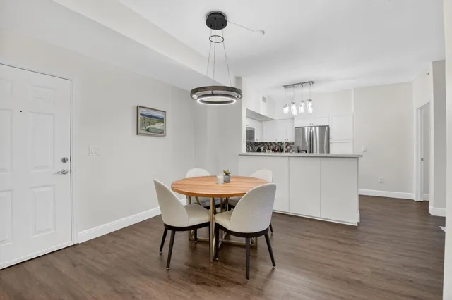 a view of a dining room with furniture window and wooden floor