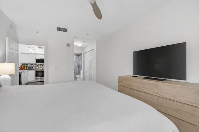 a bedroom with furniture and a flat screen tv