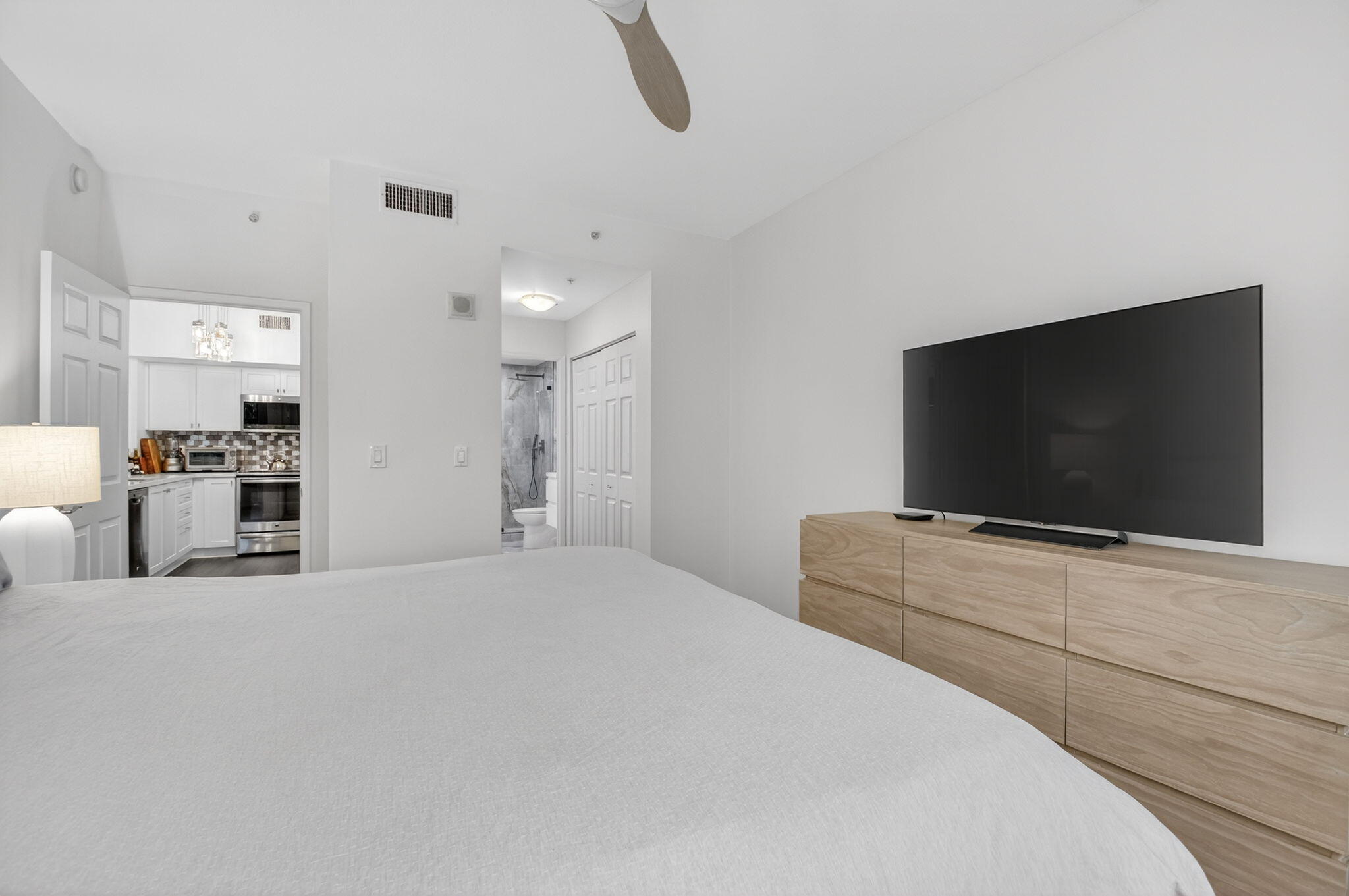 233 South Federal Highway, Unit 423 Boca Raton, FL 33432 - Photo 13 of 55 a bedroom with furniture and a flat screen tv