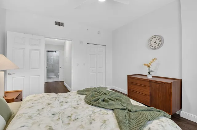 a bedroom with a bed and cabinets