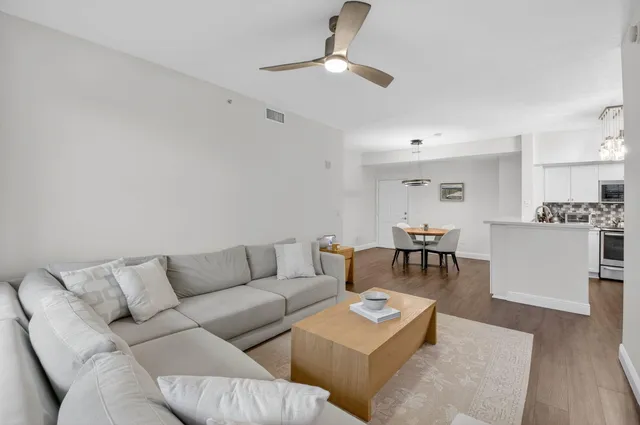 a living room with furniture and kitchen view