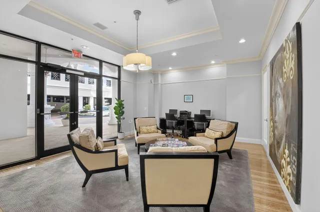 a view of a dining room with furniture and a chandelier