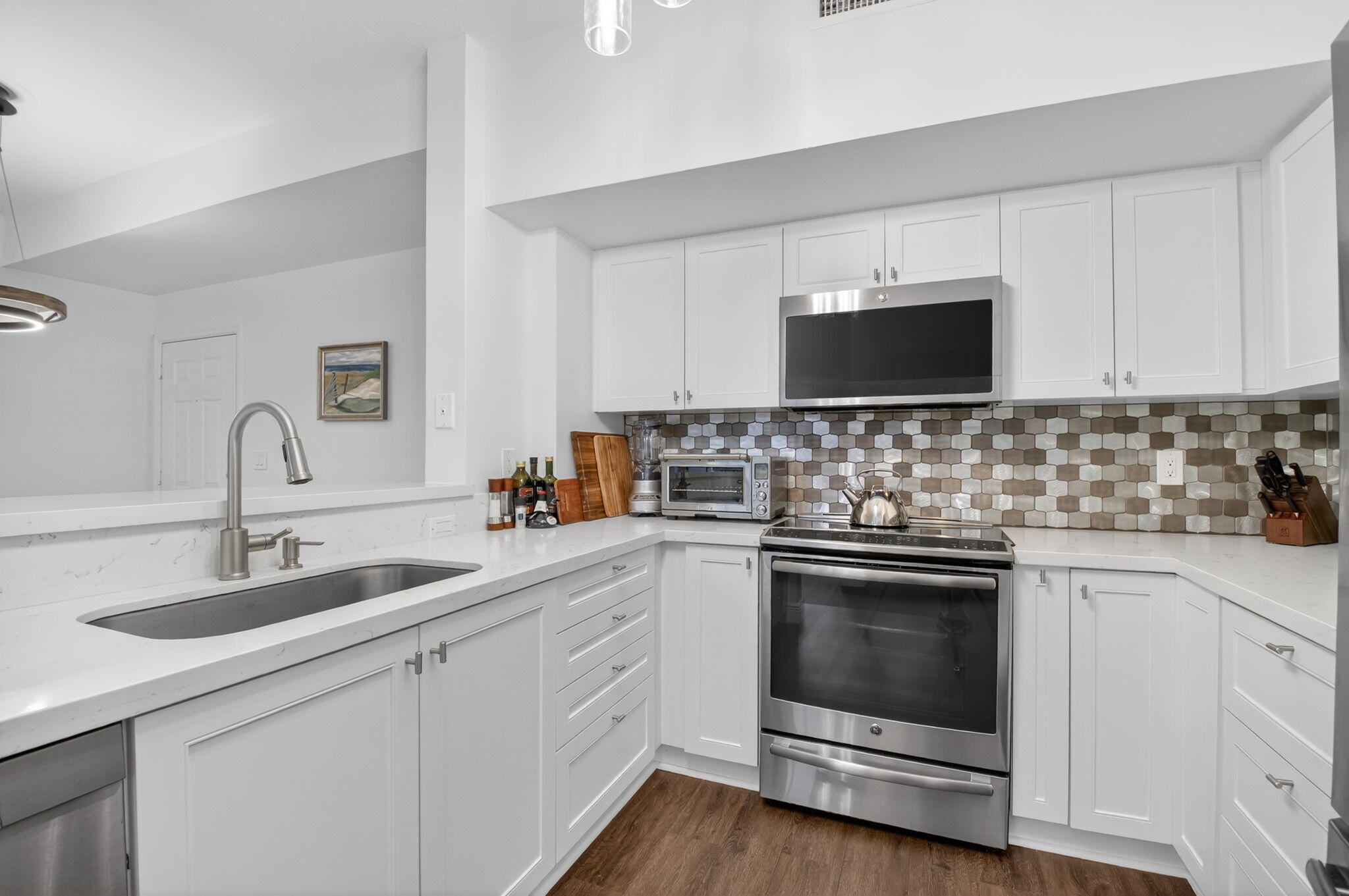233 South Federal Highway, Unit 423 Boca Raton, FL 33432 - Photo 8 of 55 a kitchen with sink a microwave and cabinets