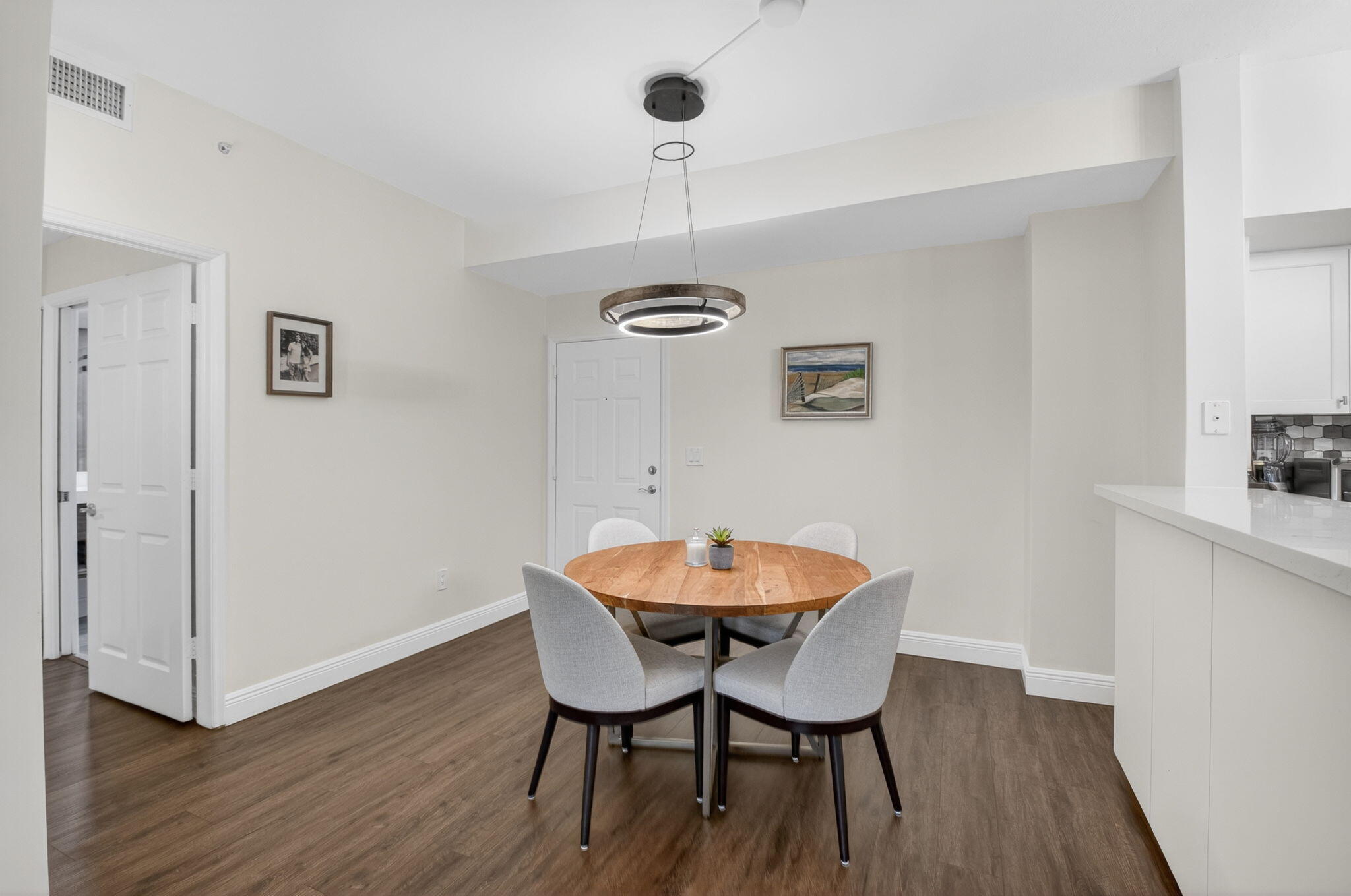 233 South Federal Highway, Unit 423 Boca Raton, FL 33432 - Photo 10 of 55 a view of a dining room with furniture and wooden floor