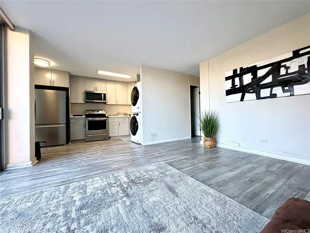 a view of a kitchen with a sink and refrigerator