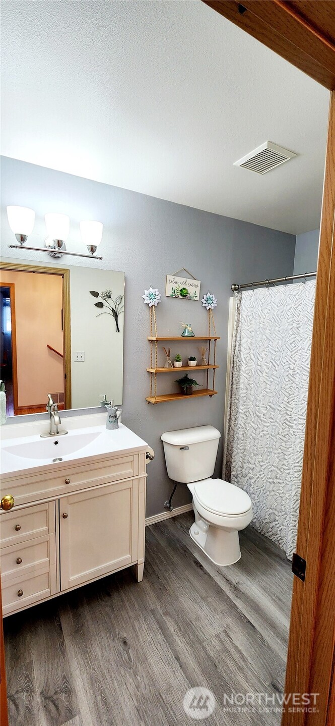 8902 West Mall Drive Everett, WA 98208 - Photo 13 of 23 a bathroom with a double vanity sink toilet and mirror