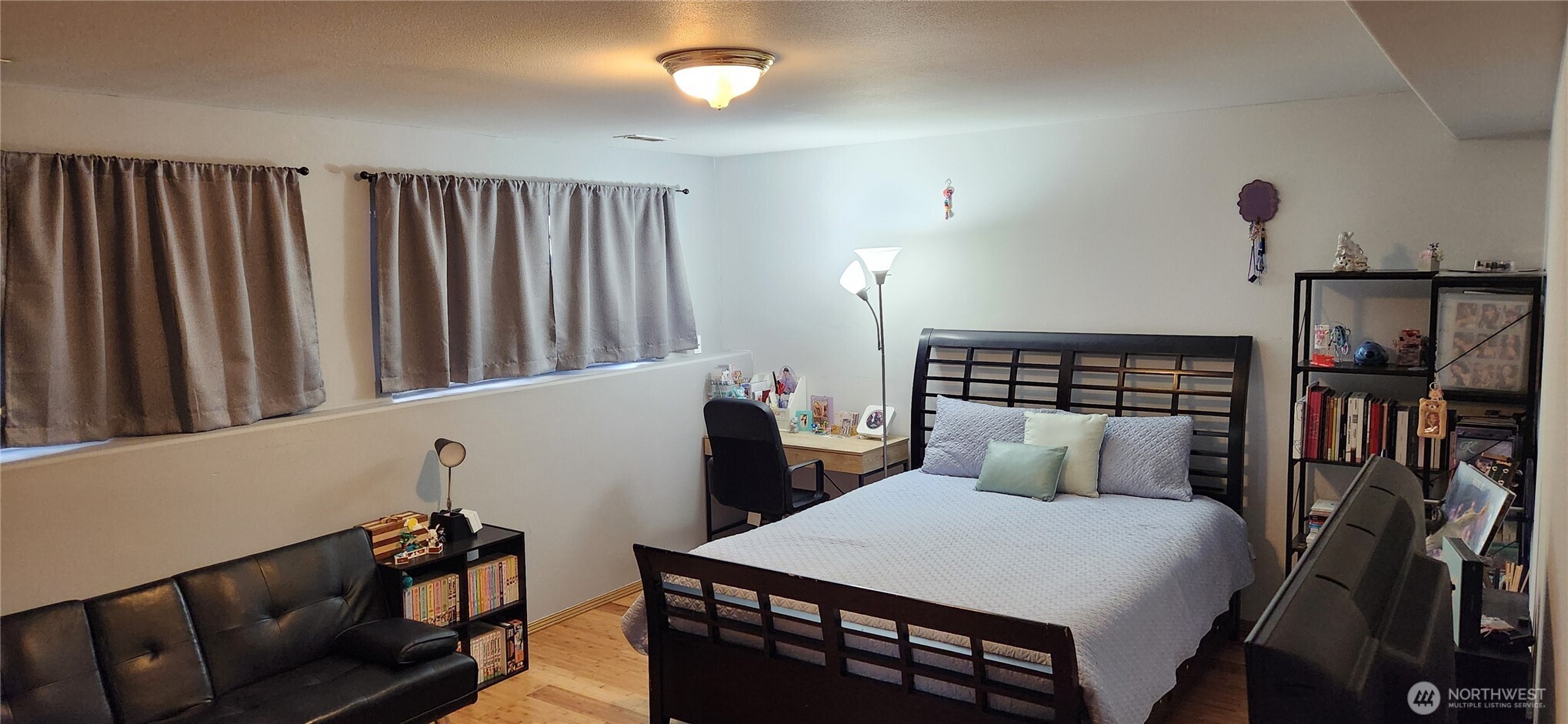 8902 West Mall Drive Everett, WA 98208 - Photo 18 of 23 a bedroom with furniture and a book shelf