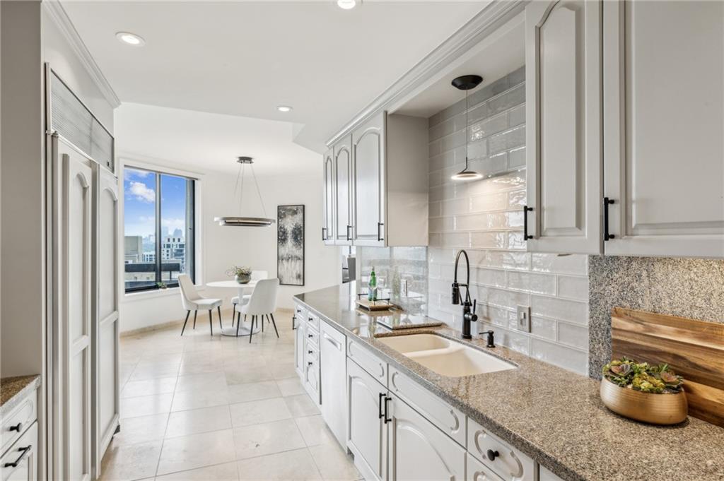 2660 Peachtree Road Northwest, Unit 23A Atlanta, GA 30305 - Photo 16 of 56 a kitchen with granite countertop a sink and a stove top oven