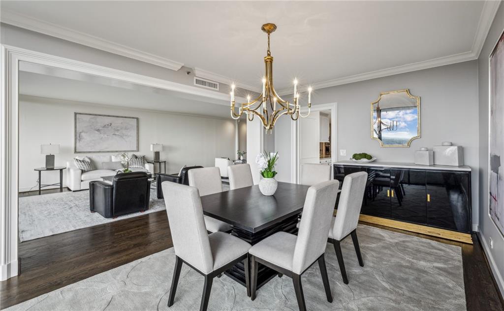 2660 Peachtree Road Northwest, Unit 23A Atlanta, GA 30305 - Photo 23 of 56 a view of a dining room with furniture and wooden floor