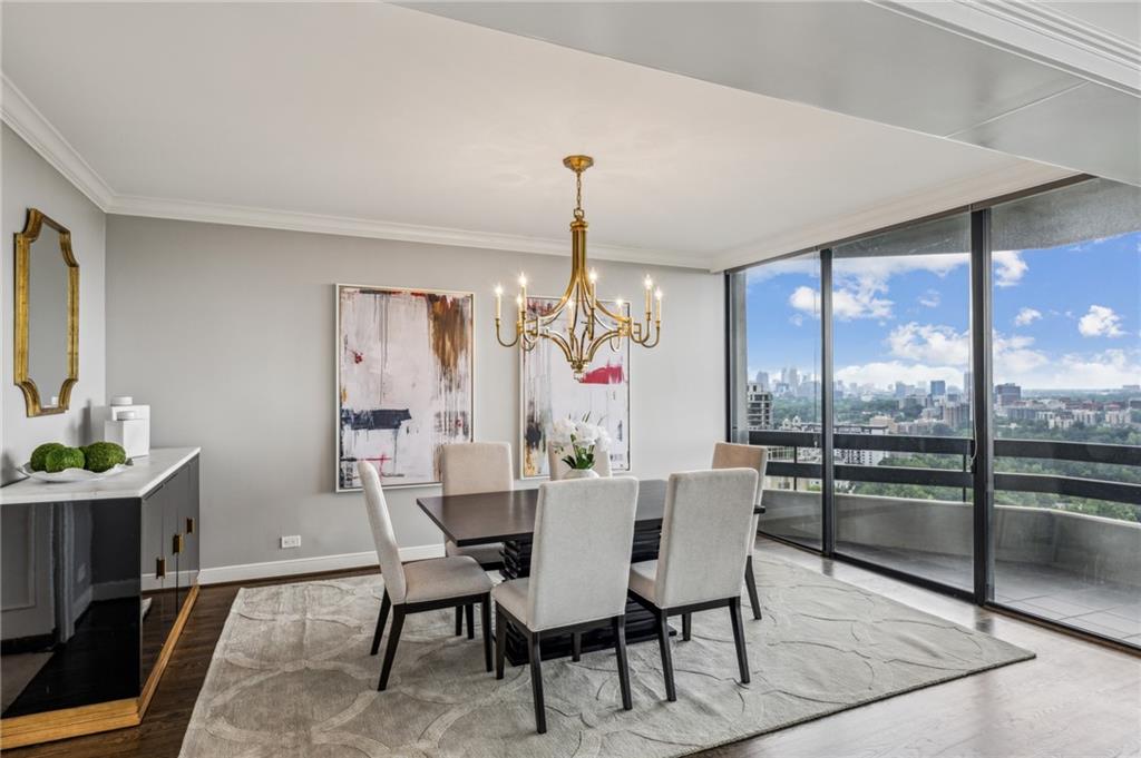 2660 Peachtree Road Northwest, Unit 23A Atlanta, GA 30305 - Photo 26 of 56 a dining room with furniture a chandelier and window