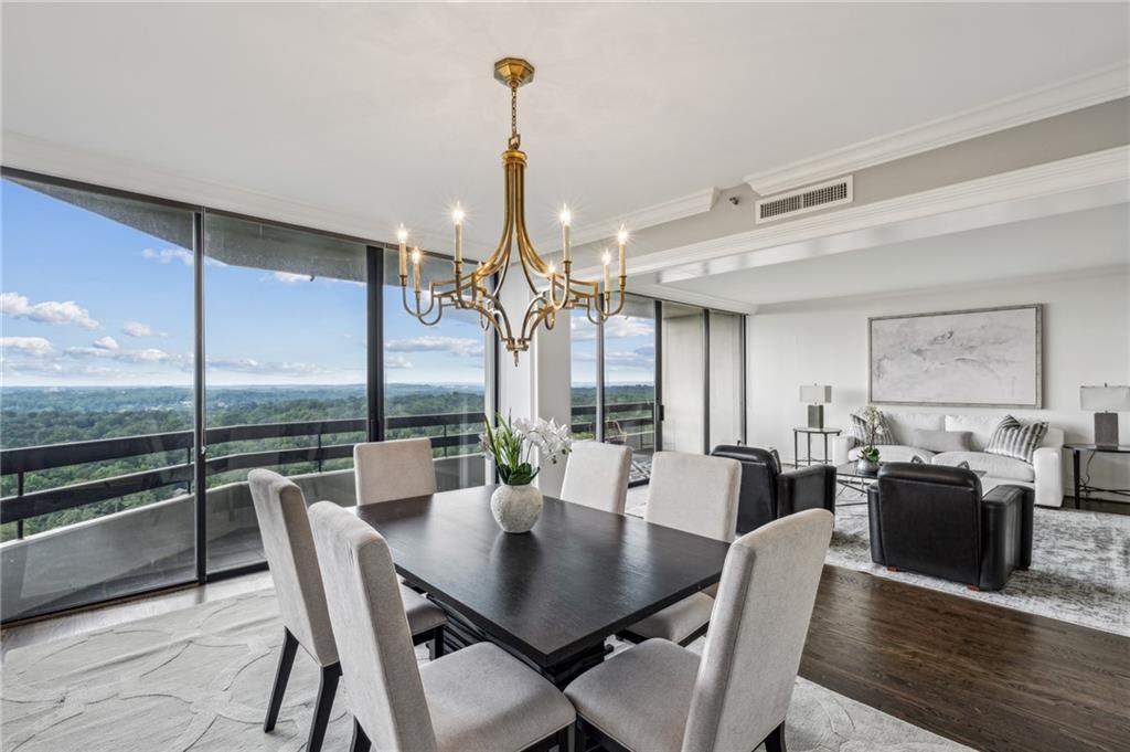 2660 Peachtree Road Northwest, Unit 23A Atlanta, GA 30305 - Photo 27 of 56 a view of a dining room with furniture window and wooden floor