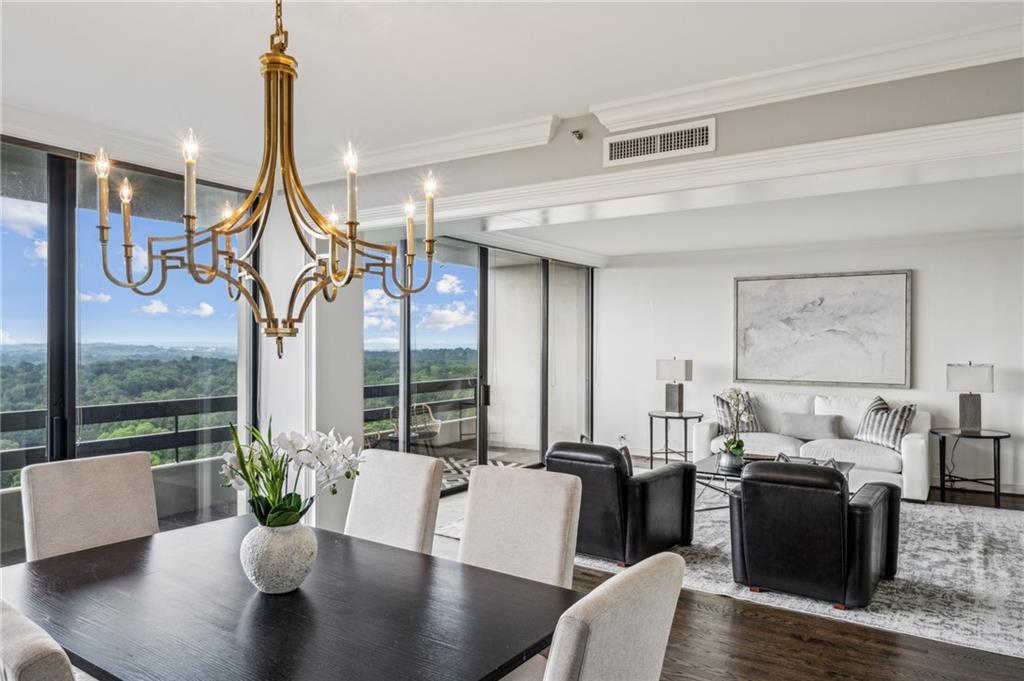 2660 Peachtree Road Northwest, Unit 23A Atlanta, GA 30305 - Photo 28 of 56 a view of a dining room with furniture a chandelier and wooden floor