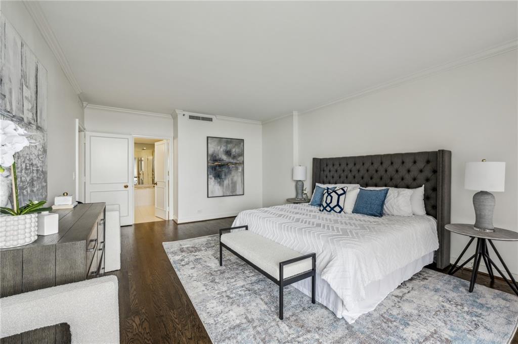 2660 Peachtree Road Northwest, Unit 23A Atlanta, GA 30305 - Photo 29 of 56 a bedroom with a bed a couch and a dresser