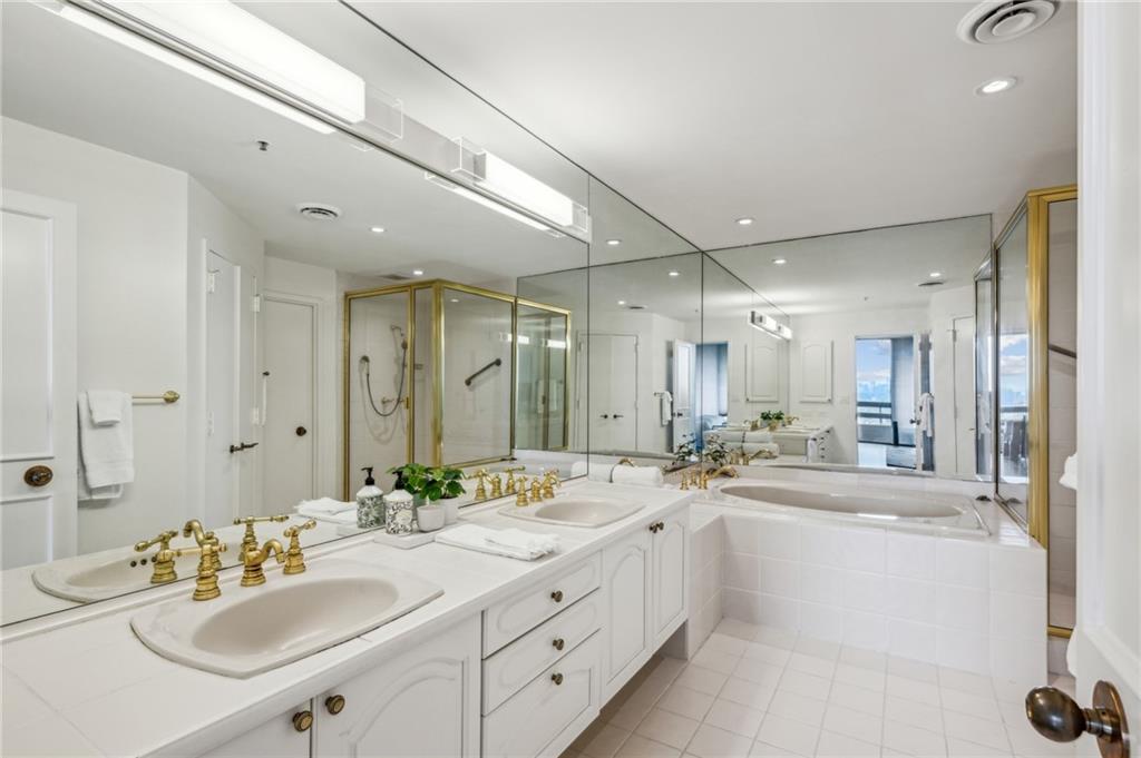 2660 Peachtree Road Northwest, Unit 23A Atlanta, GA 30305 - Photo 30 of 56 a bathroom with a sink double vanity and a mirror