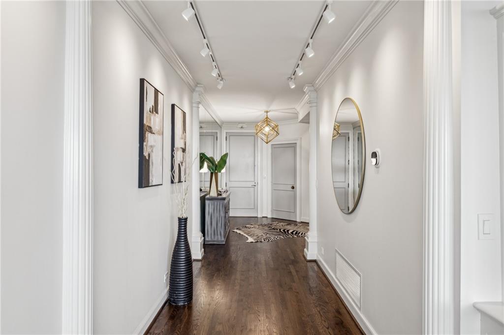 2660 Peachtree Road Northwest, Unit 23A Atlanta, GA 30305 - Photo 6 of 56 a view of a hallway with wooden floor and staircase