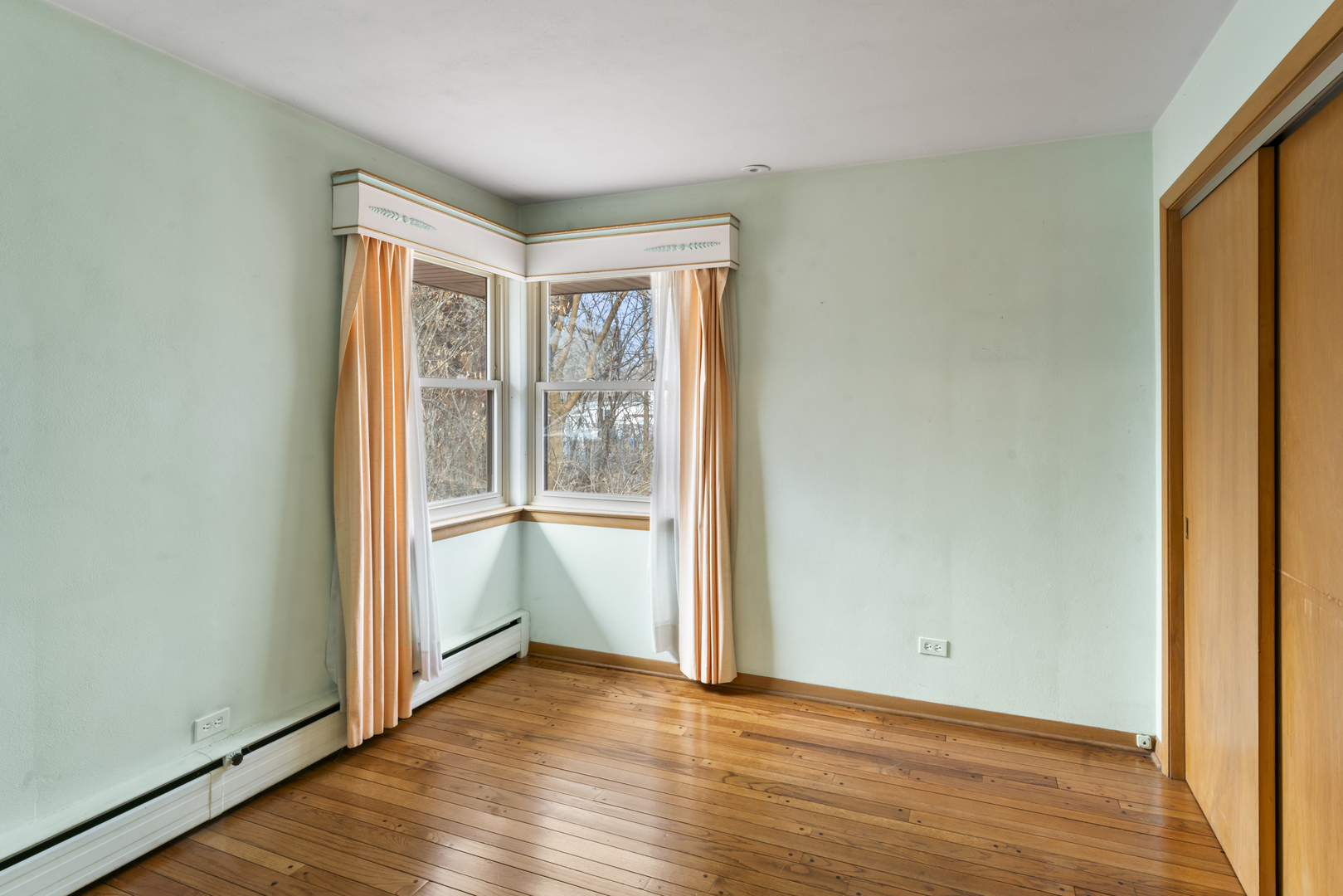 938 Hillcrest Road Elgin, IL 60123 - Photo 14 of 24 an empty room with wooden floor and windows