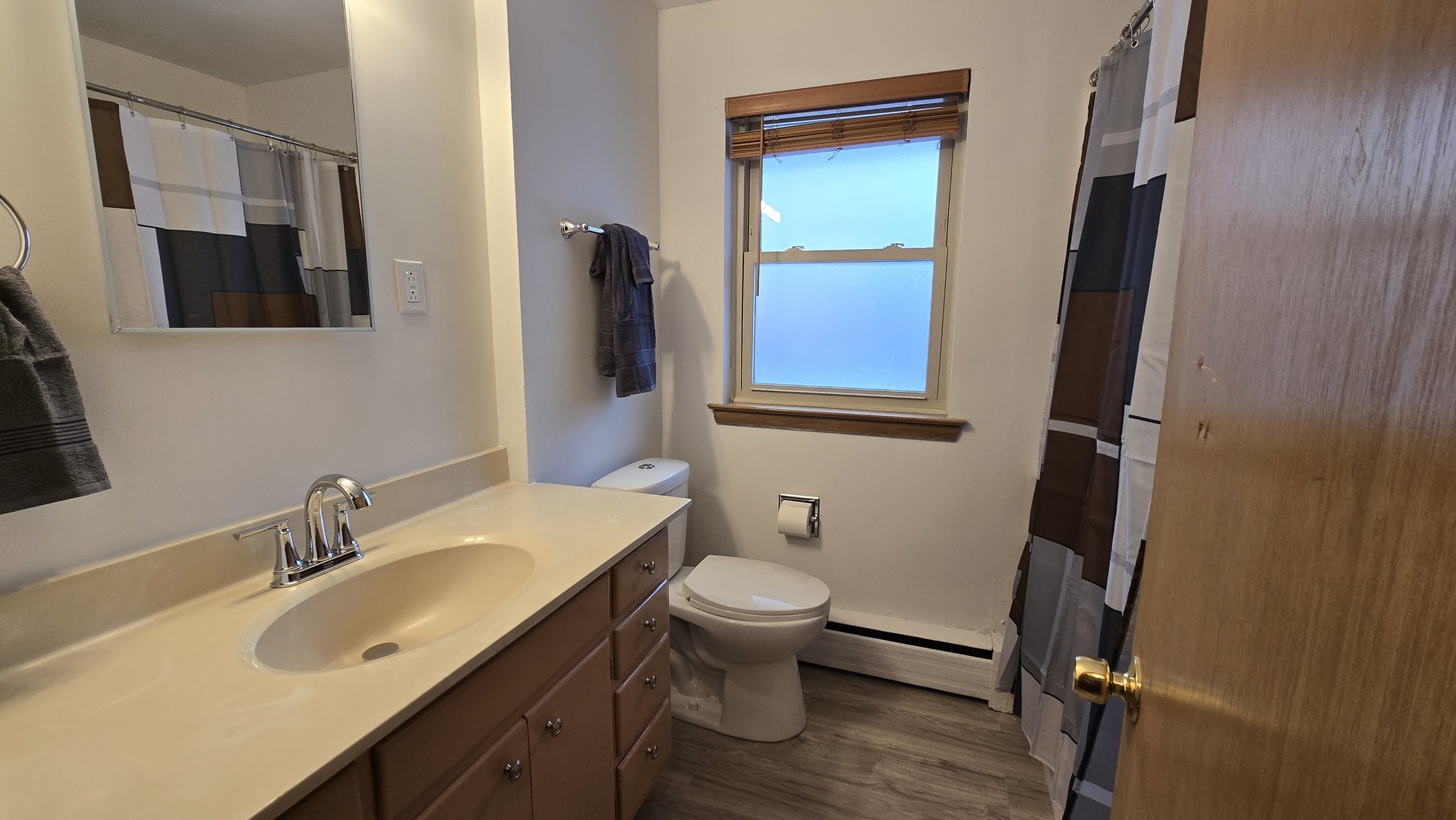 938 Hillcrest Road Elgin, IL 60123 - Photo 9 of 24 a bathroom with a granite countertop sink toilet and a mirror