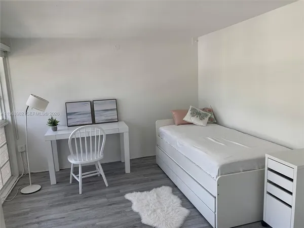 a bedroom with a bed and a chair