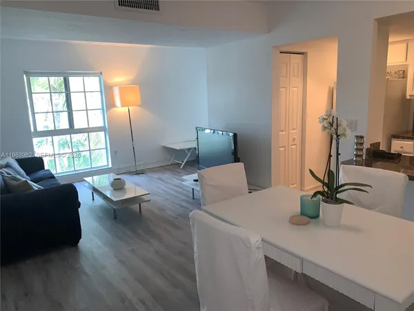 a living room with furniture and a window