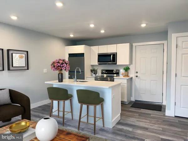 a kitchen with stainless steel appliances a dining table and chairs