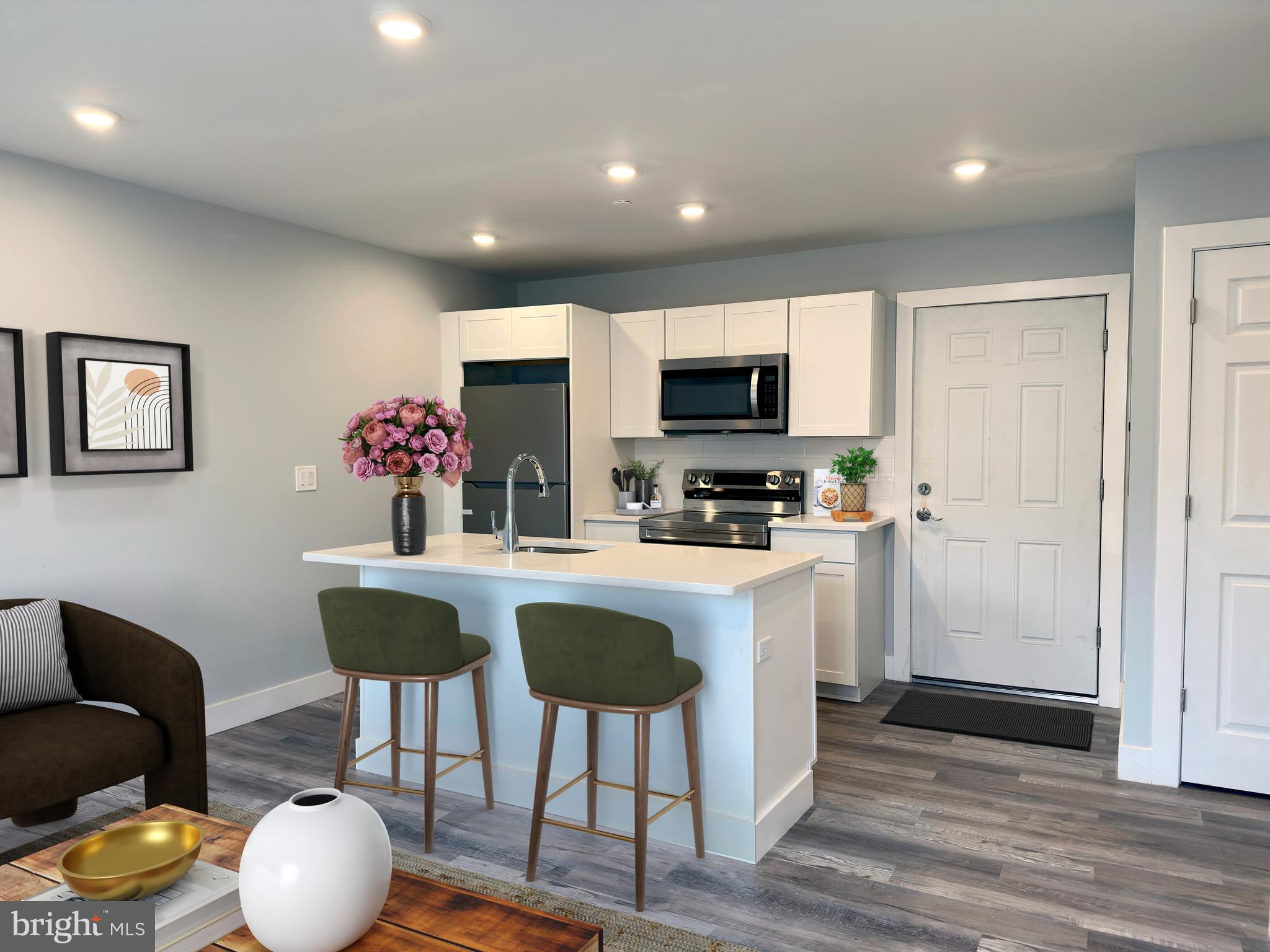 2809 South Warnock Street Philadelphia, PA 19148 - Photo 3 of 17 a kitchen with stainless steel appliances a dining table and chairs
