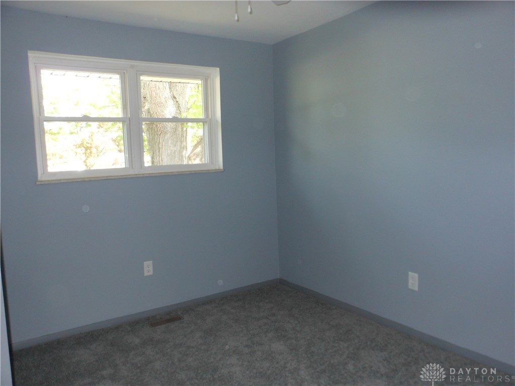 143 West Emerick Road West Milton, OH 45383 - Photo 22 of 37 This inviting bedroom offers comfort and a tranquil atmosphere with soft, carpeted flooring.