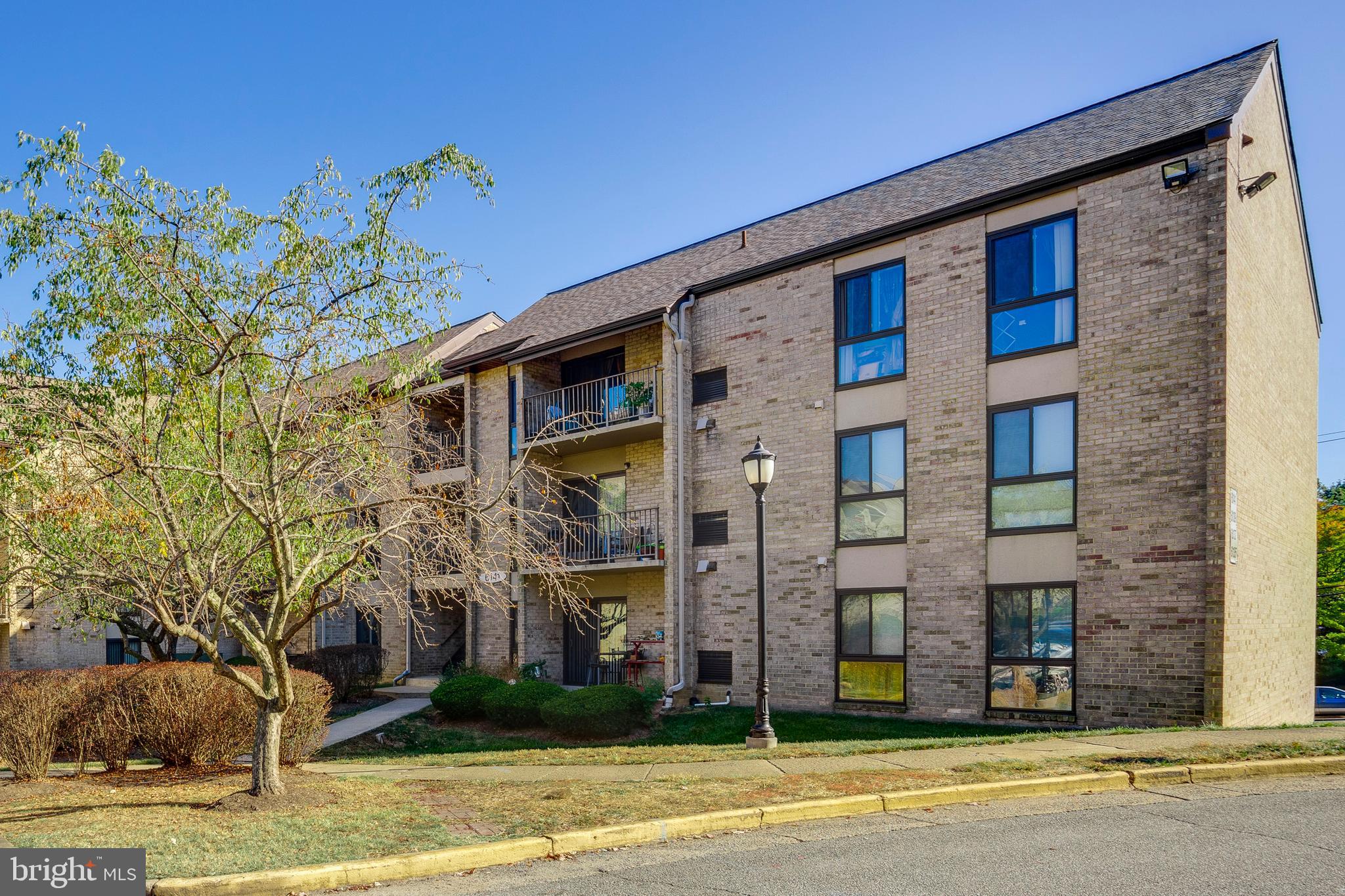 6141 Edsall Road, Unit H Alexandria, VA 22304 - Photo 1 of 29 a view of a brick building next to a yard