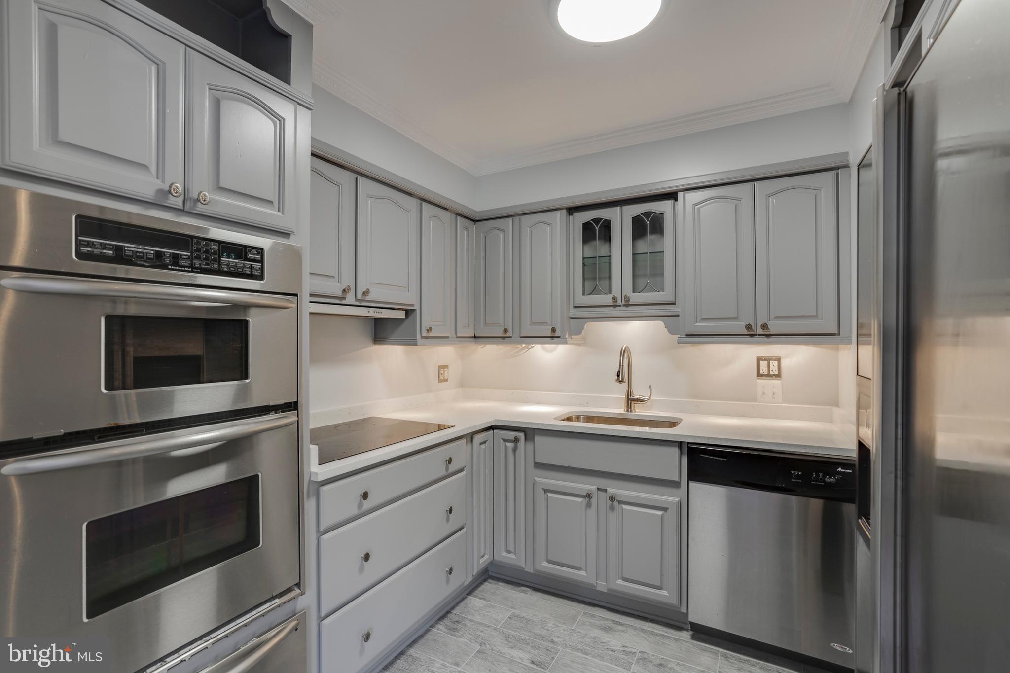 6141 Edsall Road, Unit H Alexandria, VA 22304 - Photo 13 of 29 a kitchen with granite countertop cabinets stainless steel appliances and a sink