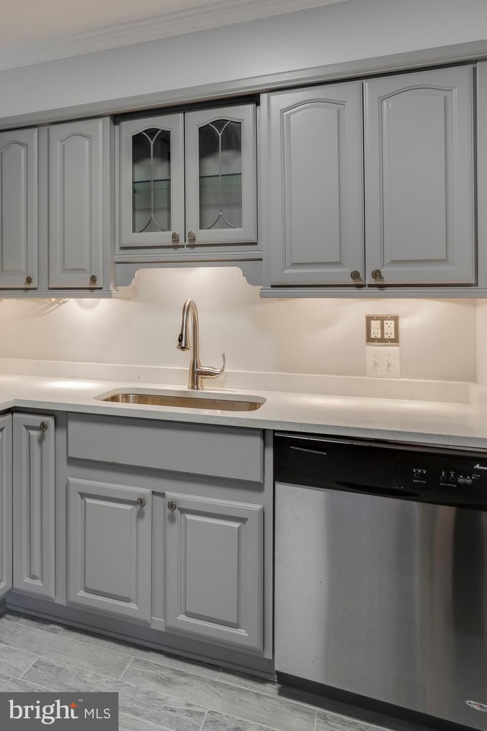 6141 Edsall Road, Unit H Alexandria, VA 22304 - Photo 14 of 29 a close view of a sink and dishwasher with wooden cabinets