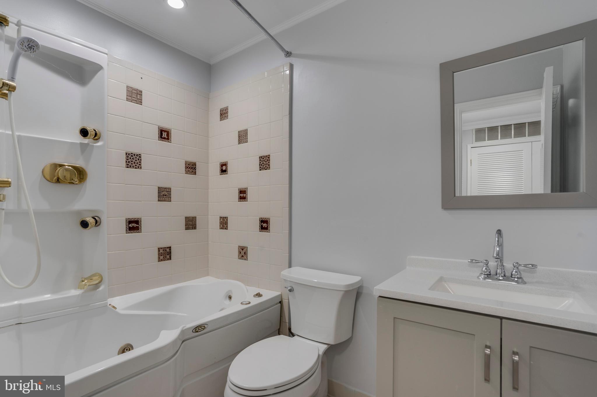 6141 Edsall Road, Unit H Alexandria, VA 22304 - Photo 21 of 29 a bathroom with a granite countertop sink a toilet a mirror a bathtub and shower