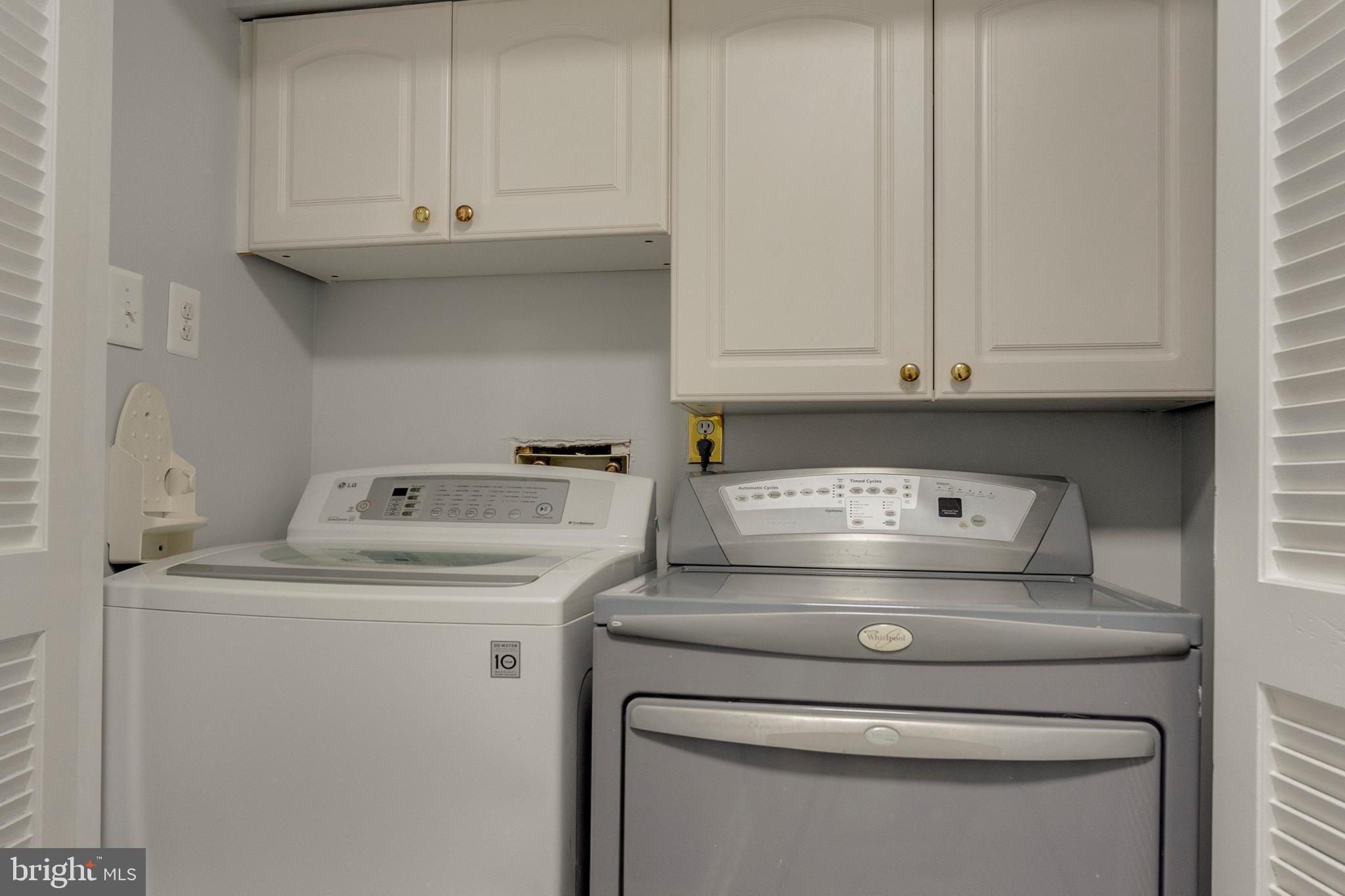 6141 Edsall Road, Unit H Alexandria, VA 22304 - Photo 25 of 29 a view of washer and dryer with white cabinets