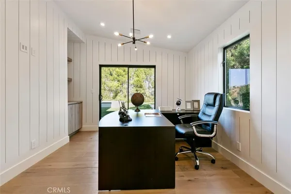 a view of a workspace with furniture and a window