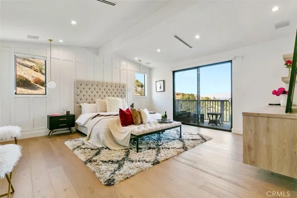 a living room with furniture and a floor to ceiling window